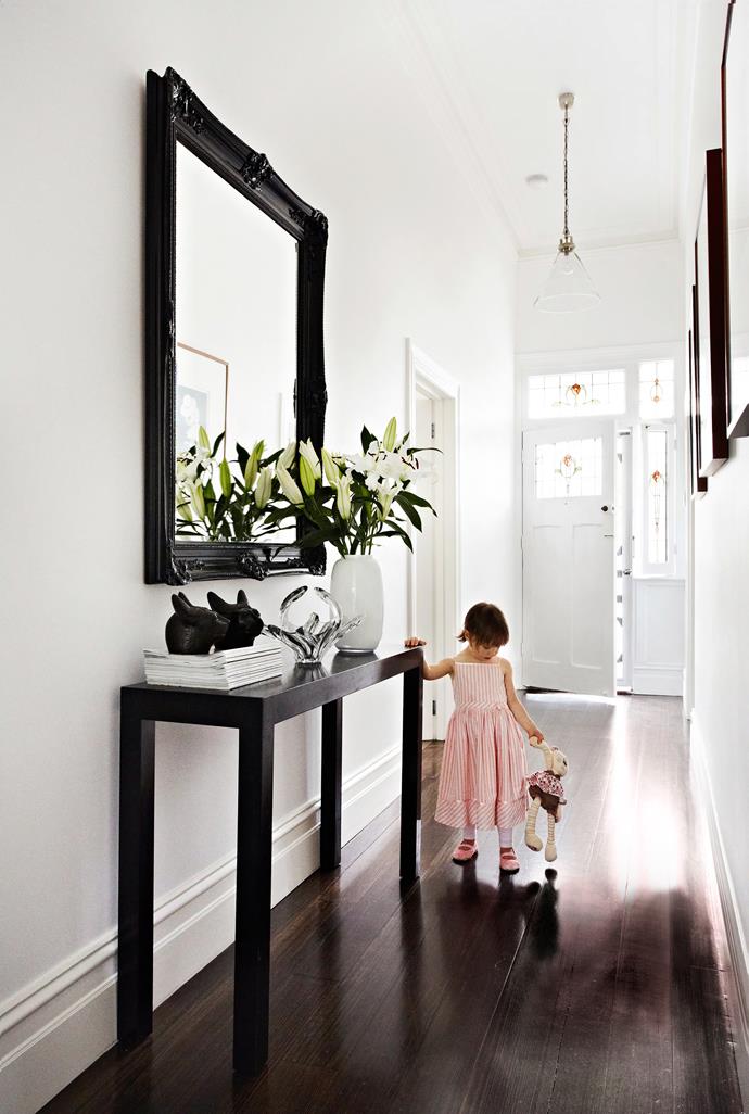 Punctuating the hallway in this Melbourne home is a hall table from [Mossgreen Auctions](http://www.mossgreen.com.au/content/|target="_blank"). A mirror sourced from [eBay](http://www.ebay.com.au/|target="_blank") was painted to match. These pieces complement the elegant design of the entrance to the restored Edwardian home. Walls are painted [Dulux](http://www.dulux.com.au/|target="_blank") Lexicon and the floorboards are Victorian ash, finished with [Feast Watson](http://www.feastwatson.com.au/|target="_blank") Black Japan.