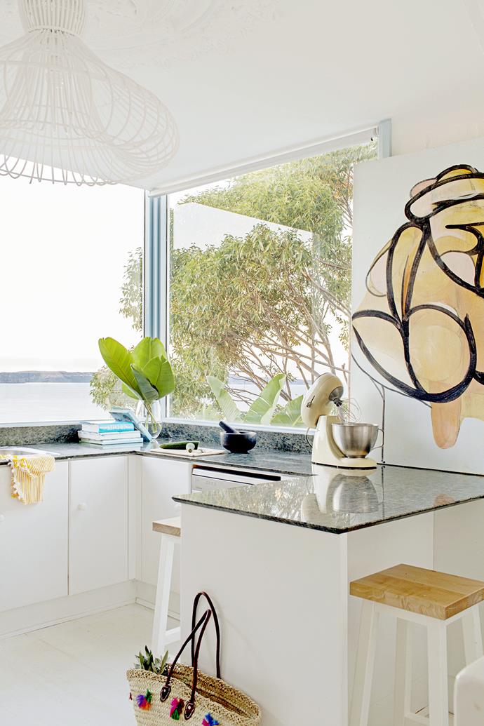 Simple white kitchen cabinetry allows the amazing view over Palm Beach and Pittwater to take centre stage. The striking artwork is by [Henry Curchod](http://www.henrycurchod.com/|target="_blank").