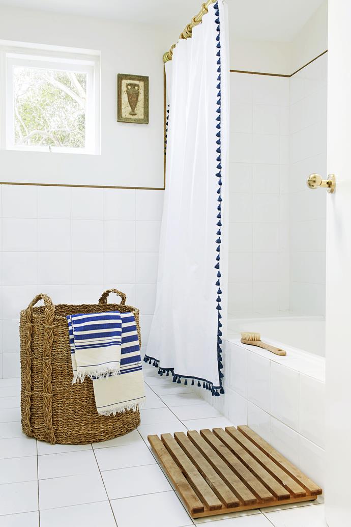 A bolt of blue, via towels and a fun pompom showerscreen that Heidi found in the US, lifts the white bathroom scheme.