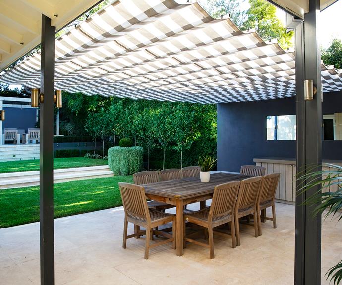 Outdoor dining area under patio roof