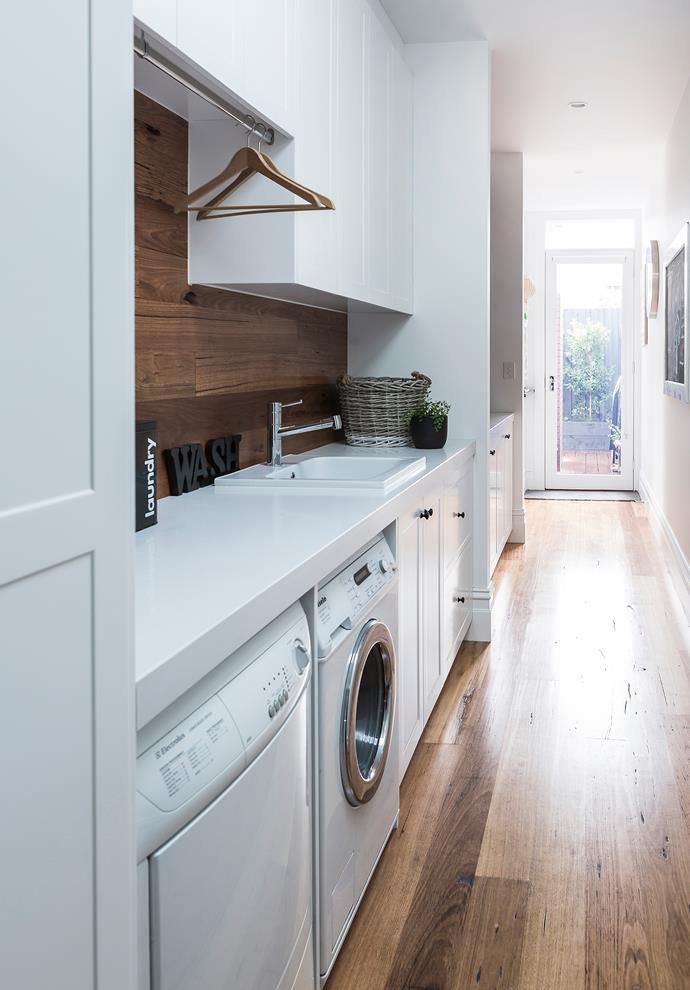A narrow hallway leading to the backyard was turned into a practical yet pretty internal laundry.