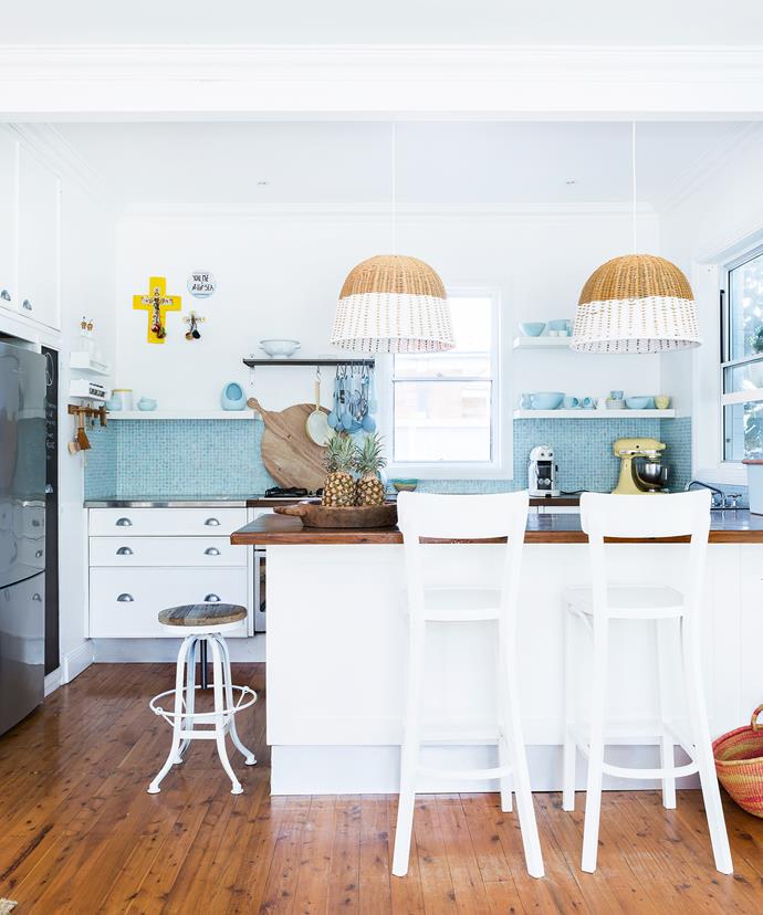 The pendant lamps from [Freedom](http://www.freedom.com.au/|target="_blank") are a great focal point in the breezy kitchen space. "A friend handcrafted our timber benchtop. We absolutely love it and it still works 12 years later – it's aged beautifully."