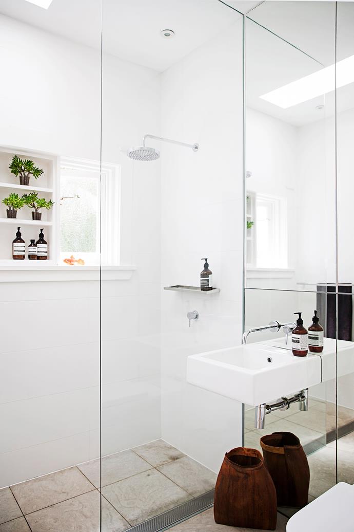 The old bathroom has been renovated. The addition of a floor-to-ceiling mirror and a frameless shower screen maximise the sense of light and space in the small room.