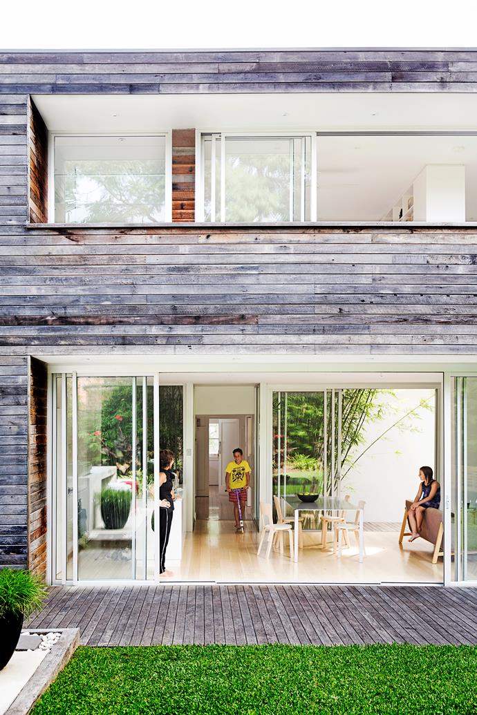To achieve the Swiss-style look, homeowners Ariana and Peter Koller used traditional recycled hardwood shiplapped cladding on the exterior of their family home in Sydney's Earlwood, where a two-storey extension has been added at the back of the old single-storey cottage. Upstairs is a bedroom, ensuite, living area and balcony. Downstairs are the new kitchen, dining and living areas.