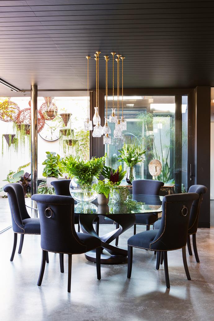 **Best lighting: [Arc Seven.1](http://www.arc-seven1.com.au/|target="_blank")**
Carved out of the garden of a 1930s house in Perth, this dining room by Arc Seven.1 is connected to the outdoors by frameless glass sliding doors. “Clever and unexpected choice of lighting such as the pendant clusters above the dining area to the exterior feature lights add a touch of glamour to this lush, botanical space,” says Lucy Sutherland. “A collection of lights at various levels always makes a bold statement. I have done a similar thing on a larger scale in the Crosby Bar in New York and The Dive Bar at Ham Yard Hotel in London," adds Kit Kemp. 
Photo: James Knowler