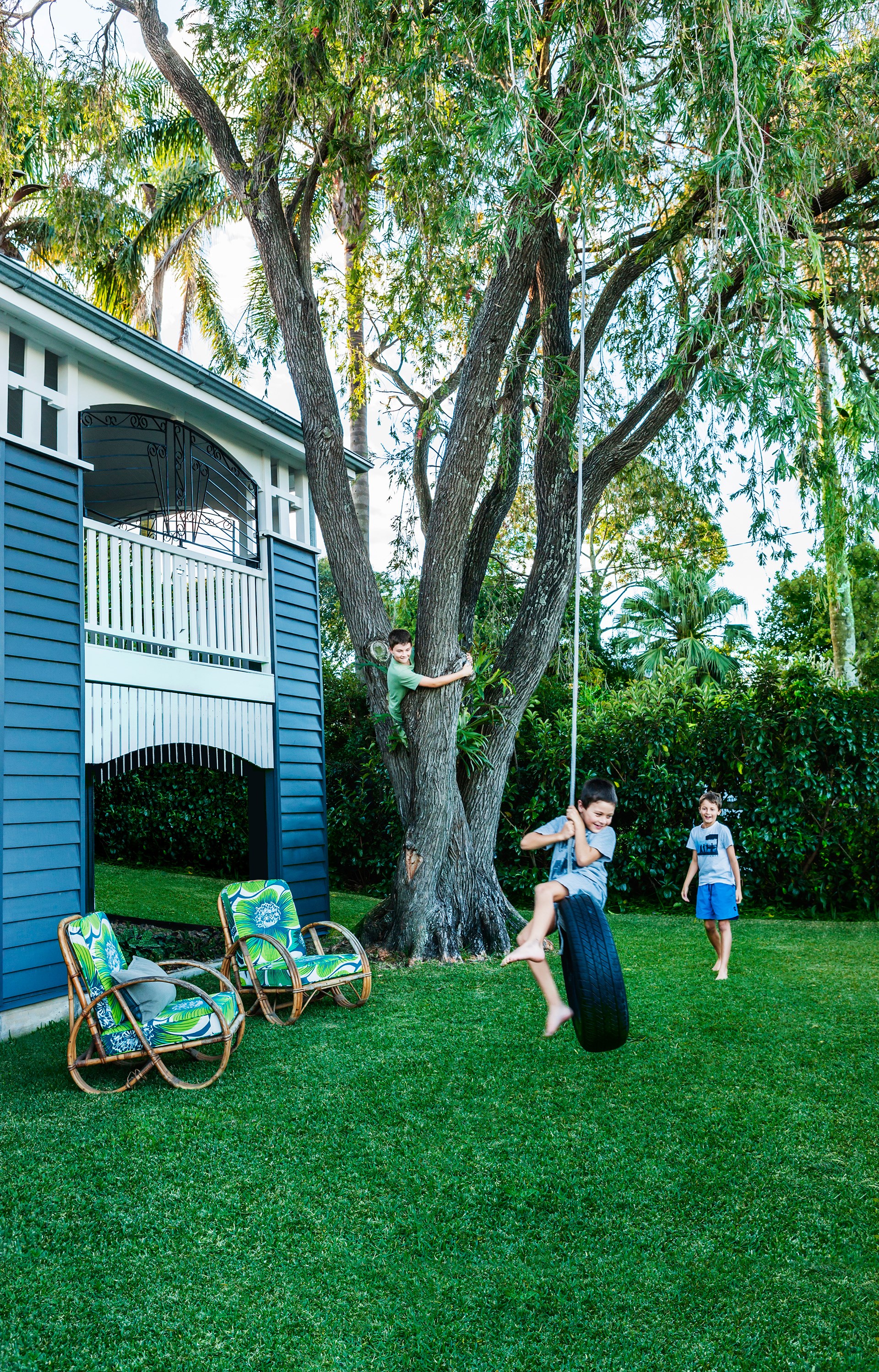 Brothers Tom, Ned and James (from left) make the most of their spacious garden and tire swing. Take the tough of [this renovated country-style Queenslander](http://www.homestolove.com.au/gallery-bettina-and-davids-renovated-queenslander-2224/|target="_blank").