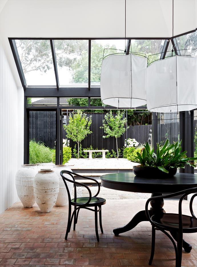 The atrium, added to the home during its previous renovation, overlooks a **garden** by [Peter Fudge Gardens](http://peterfudgegardens.com.au/?utm_campaign=supplier/|target="_blank"). 

Thonet ‘Le Corbusier’ **armchairs**. Existing **dining table** was stained black. White **lampshades** and **urns** from [Les Interieurs](http://www.lesinterieurs.com.au/?utm_campaign=supplier/|target="_blank").