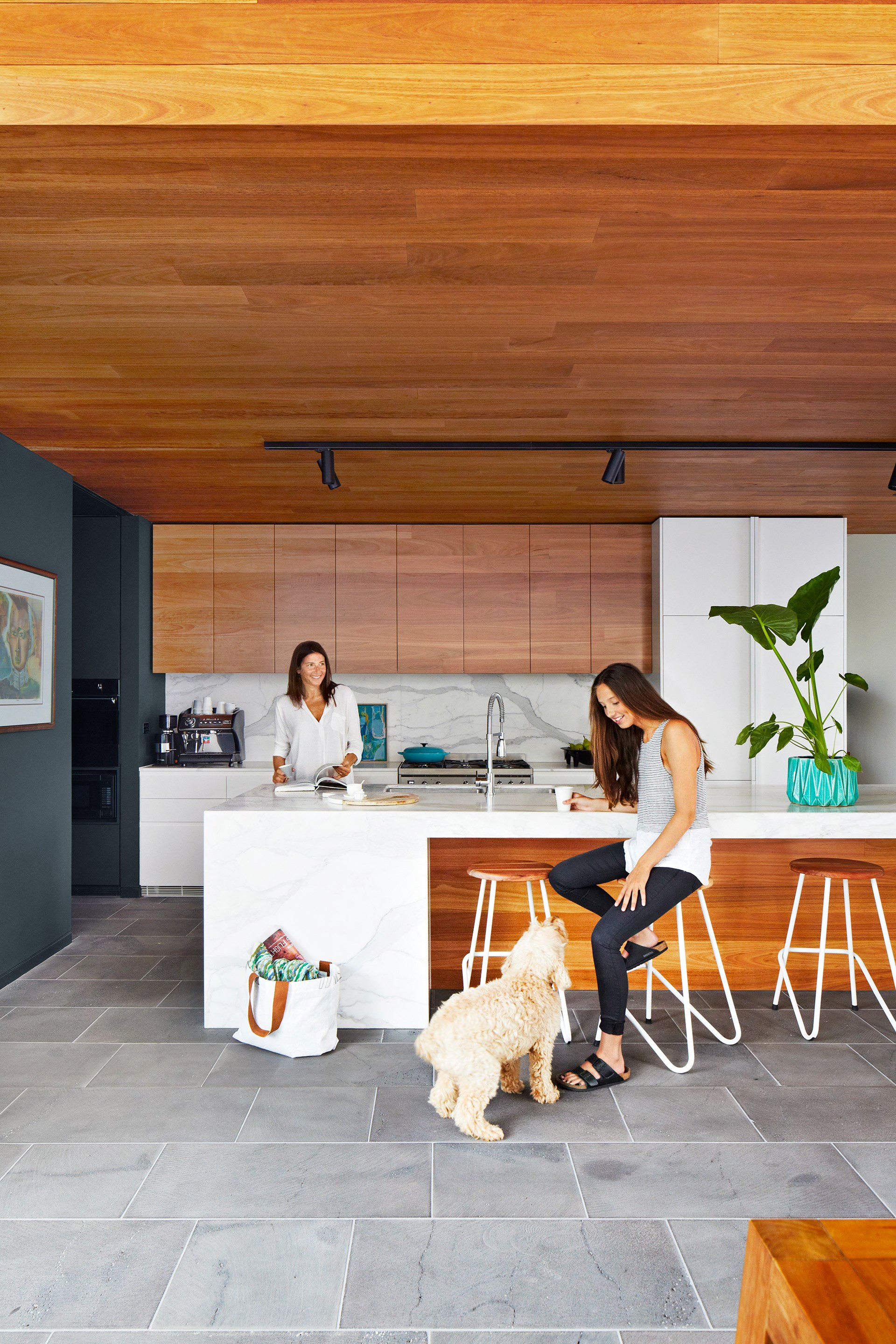 A blackbutt timber clad ceiling adds warmth and coziness to the streamlined kitchen within this [Modernist Melbourne home](http://www.homestolove.com.au/gallery-stephen-and-tanyas-melbourne-home-reno-2286).