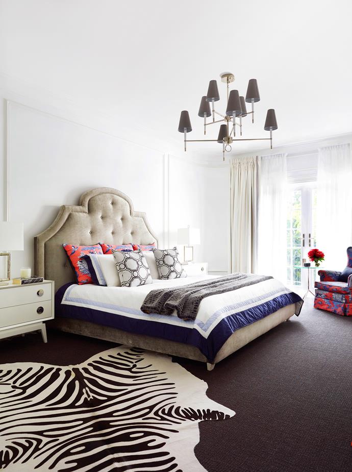 Red and navy add pizazz to the main bedroom, which was once the old upstairs apartment’s living room. French doors and balconies off the first floor rooms ensure a strong indoor-outdoor connection. Woodhouse **bed** and Claude **bedside tables** from [Jonathan Adler](http://www.jonathanadler.com/?utm_campaign=supplier/|target="_blank"). **Bedlinen** from [Williams-Sonoma](http://www.williams-sonoma.com.au/?utm_campaign=supplier/|target="_blank"). Zebra **rug** from [Orson & Blake](http://www.orsonandblake.com.au/?utm_campaign=supplier/|target="_blank").