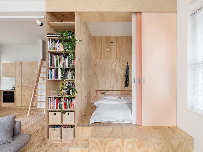 Plywood joinery separates the main bedroom from the rest of the living area in this Flinders Lane apartment by architect Clare Cousins. Photo: Lisbeth Grosmann