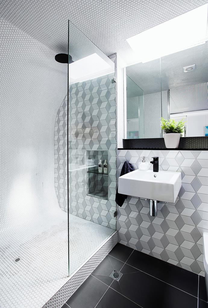 “A lack of light and height in the ensuite dictated the need to add a skylight,” says Bronwyn. The curved shower recess gives this space a cabin-like ambience, while the trompe-l’oeil shading of the wall tiles adds visual depth and complexity.
