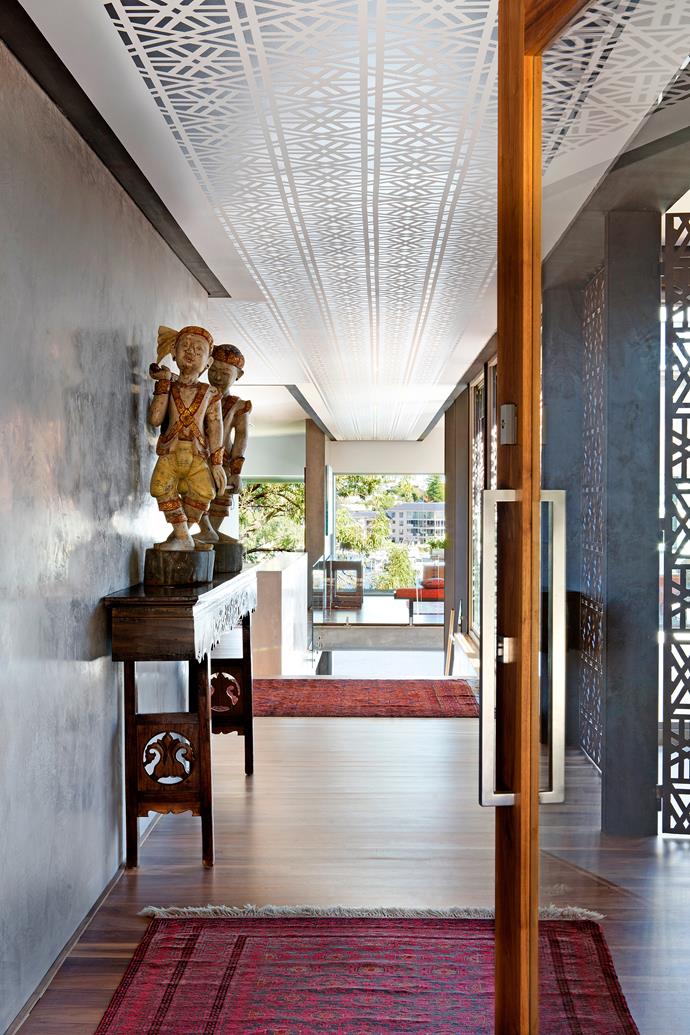 The entry door on the home's first floor pivots open to reveal a view of the Swan River. The hand-printed ceiling echoes the steel screen walls of the living room/study on the right. Burmese **statues** from [Kartique](http://www.kartique.com.au/?utm_campaign=supplier/|target="_blank"). **Screens** from [Strategic Marine](http://www.strategicmarine.com/?utm_campaign=supplier/|target="_blank").