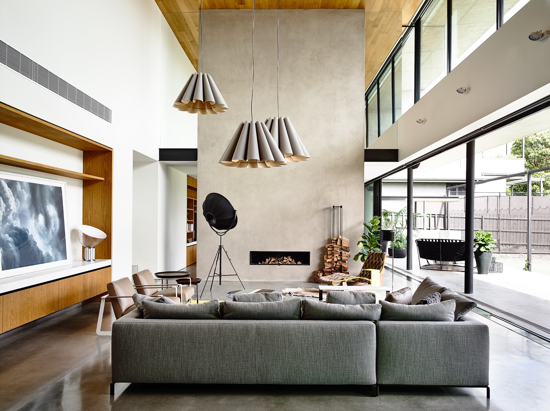 Deftly folded pendant lights floating above the furniture add a delicate and somewhat ethereal touch to this vast modern living room. Take a tour of this [modernist marvel in Melbourne](http://www.homestolove.com.au/expansive-modernist-house-in-melbourne-2426|target="_blank"). Photo: Derek Swalwell / *Belle*
