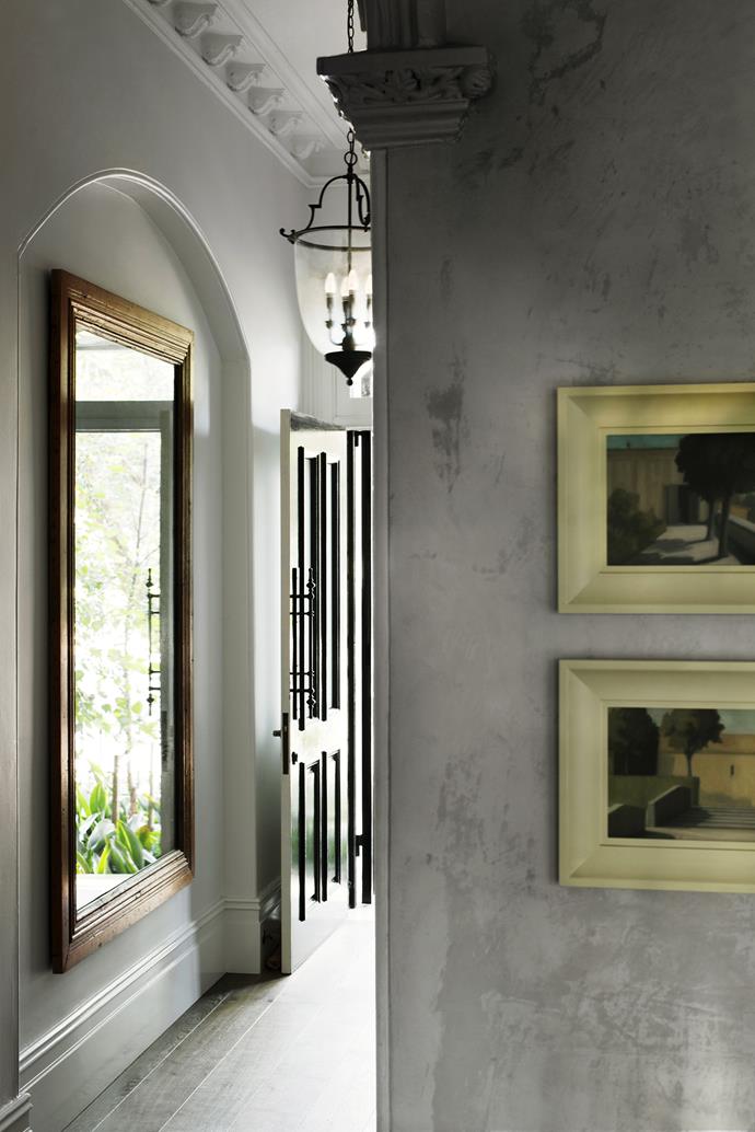 “One of the highlights of the renovation occurred when rendering the downstairs walls. We saw light flooding onto the render and quickly decided not to paint over it,” says Penny. The generous hallway entrance of ‘Mimosa’ features a recycled timber **mirror** inherited from the first house the Hanans restored in this area of Paddington, and a **chandelier** that came with the house and was restored by [Edwards Chandelierium](http://chandelierium.com.au/?utm_campaign=supplier/|target="_blank"). The two **paintings** are by [Peter Boggs](http://www.peterboggs.com/?utm_campaign=supplier/|target="_blank").