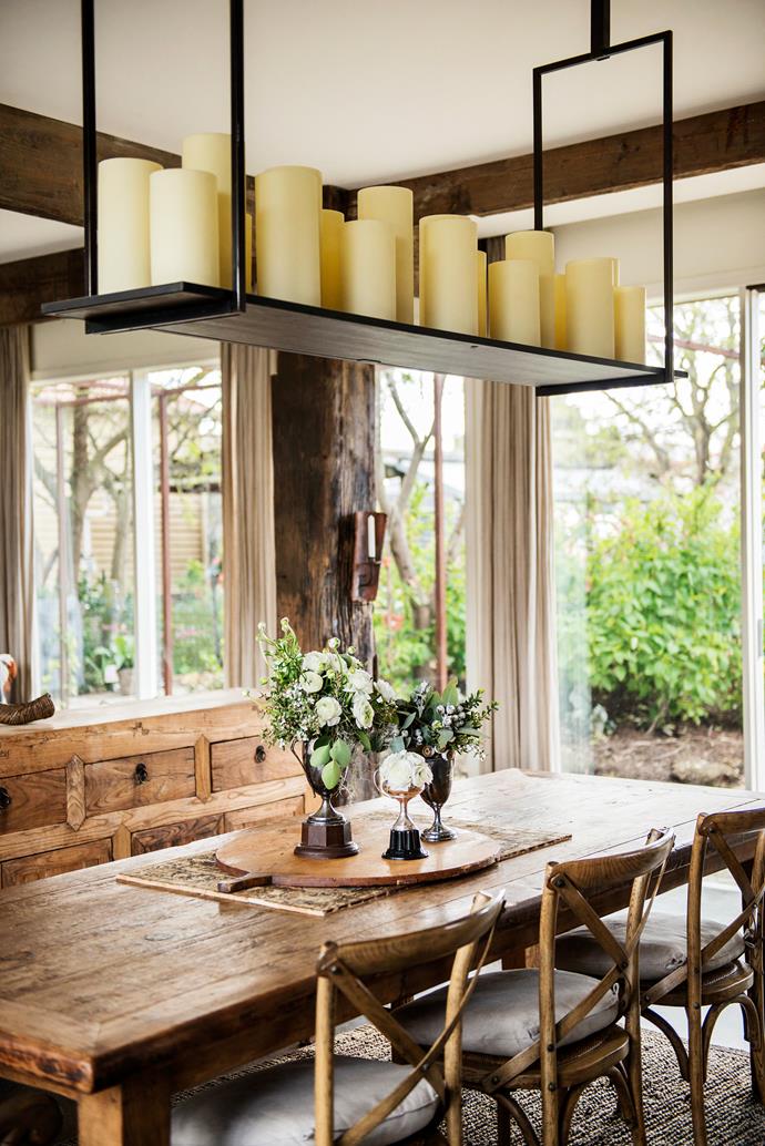 "We have a large extended family," says Joanne, "so we wanted a welcoming home with a large living space that would flow easily into the outdoor entertaining area." The large **wooden platter** came from a car boot sale in France and the **hanging candle shelf** was sourced in Bali. **Table and chairs** from [Three Oh Two Willows](https://www.facebook.com/pages/Three-Oh-Two-Willows/339673366132967/?utm_campaign=supplier/|target="_blank"). **Sideboard** from [Kyo](http://www.kyo.net.au/?utm_campaign=supplier/|target="_blank"). **Wall sconce** from [Schots Home Emporium](https://www.schots.com.au/?utm_campaign=supplier/|target="_blank"). **Flowers** from [Moss Industry Weddings & Events](http://www.mossindustryflorist.com.au/?utm_campaign=supplier/|target="_blank").