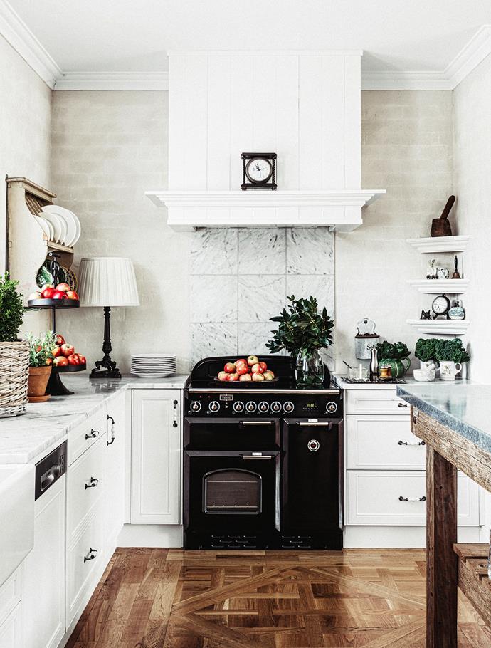 Classic kitchen in white with marble countertops and splashback. **Plate rack and plates** from [Suzie Anderson Home](http://suzie-anderson-home.myshopify.com/?utm_campaign=supplier/|target="_blank"). **Door hardware** from [Mother of Pearl & Sons](http://motherofpearl.com/?utm_campaign=supplier/|target="_blank").