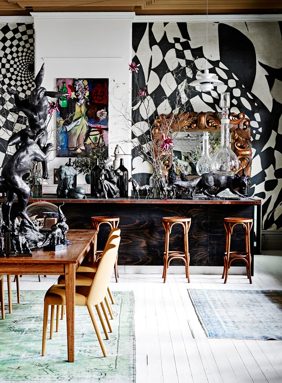 **Think outside the box:** Maximalism works just as well in a dining area, such as here in artist David Bromley's Melbourne home, which was once a Turkish bathhouse and a shopping arcade. This playful yet grand space is peppered with Christian Maas sculptures, apothecary bottles from Japan and European furniture.