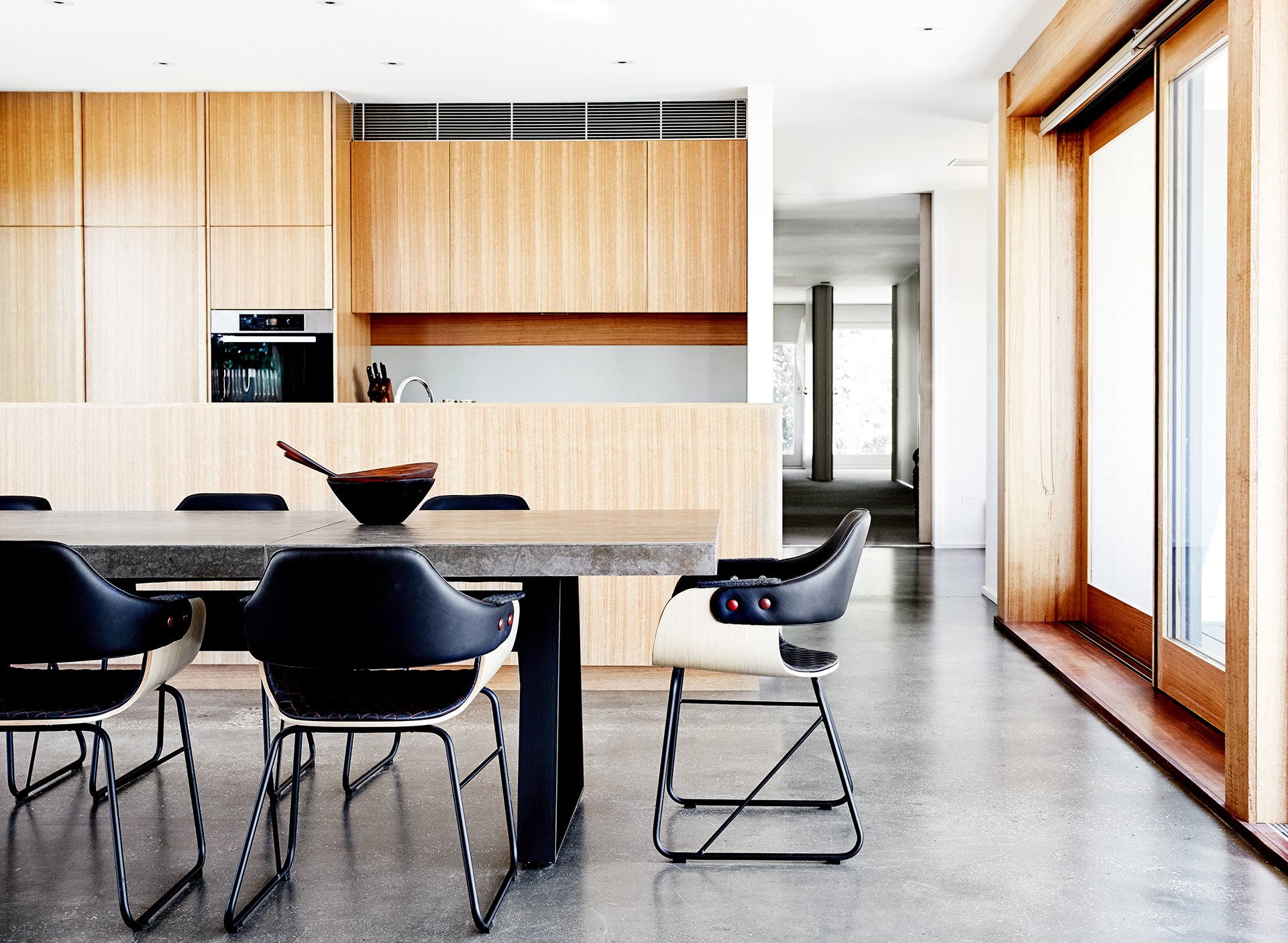 A concrete-topped table echoes the raw materials used throughout the house.