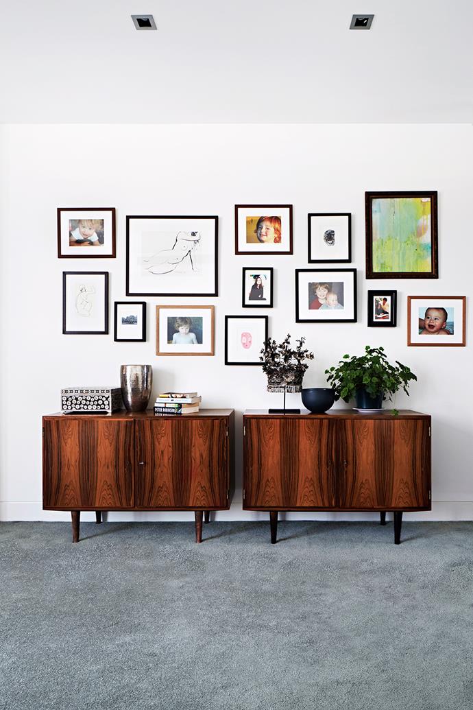 In the main bedroom, family portraits mingle with vintage artwork and framed prints from La Grolla. Vintage 1960s cabinets from [Grandfather's Axe](http://www.grandfathersaxe.com.au/|target="_blank"), customised as storage units for vinyl, join other timber notes throughout the home.