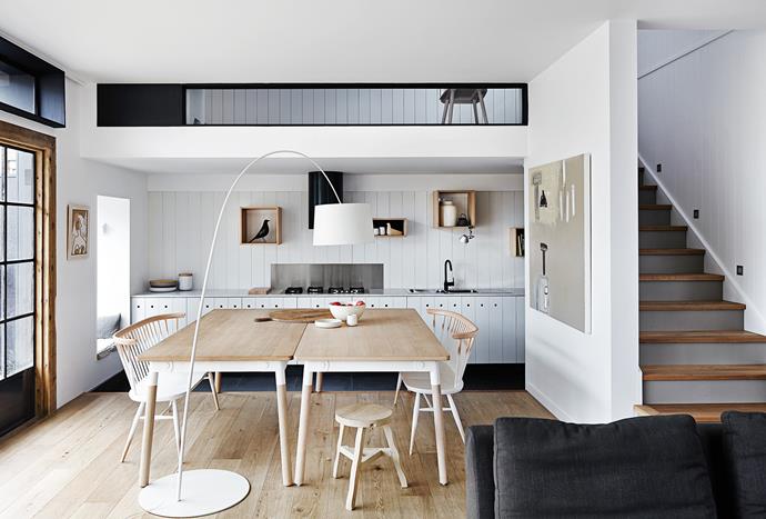 The central, open kitchen houses an oversized table that becomes a bench-height space when you step down to the kitchen level. The glazed section above the kitchen provides a visual link to a mezzanine level, allowing light in and creating a sense of connectivity.