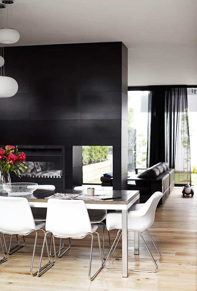 A fireplace wall divides the dining and living areas but still allows for “visual contact”, Kate says. The colour of the smoked and limed floorboards from Royal Oak Floors isn’t affected by sunlight, she adds. Dining chairs from [Sebel Furniture](http://www.sebelfurniture.com/|target="_blank").