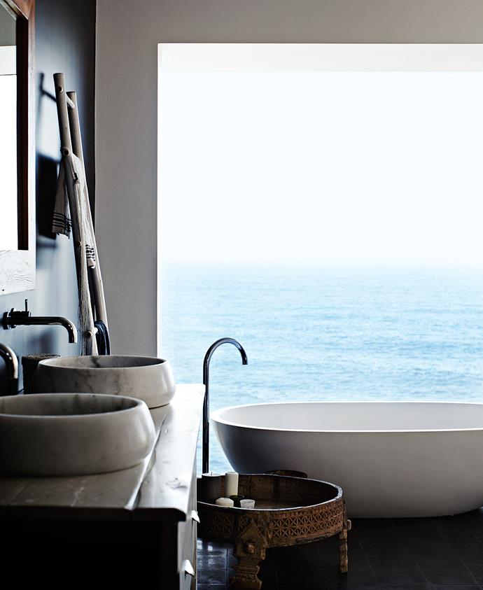 The Apaiser stone bath in the master bedroom ensuite is positioned in the best spot to take in the magnificent ocean view. The bath, along with the basins that were bought as one-offs from Indigo Tile Design, add an organic simplicity to the space. Haughey Group made the timber vanity.