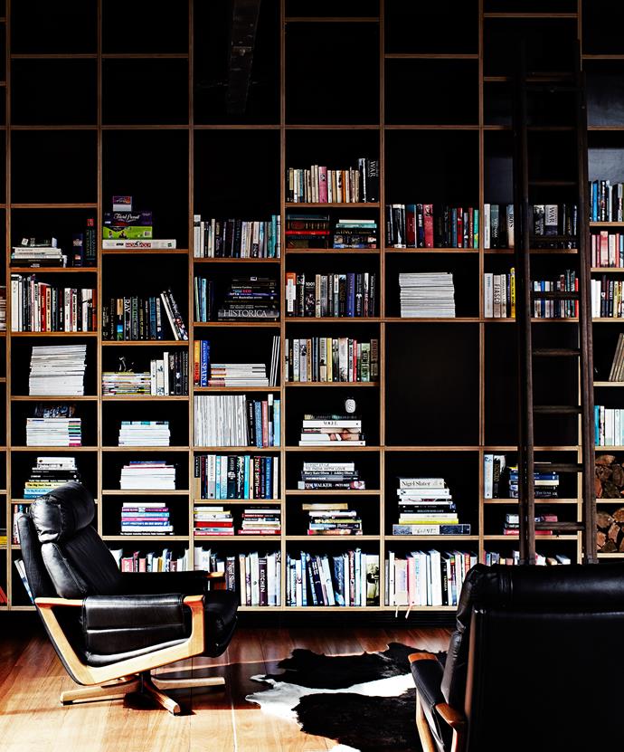 The huge bookcase, a focal point in the moody living area, contains design and art history books as well as historical tomes passed down through Merrick’s family. The quietly sophisticated furniture and furnishings – vintage Tessa armchairs and an Ikea cowhide – work with rather than compete with the building’s grand textural structure.