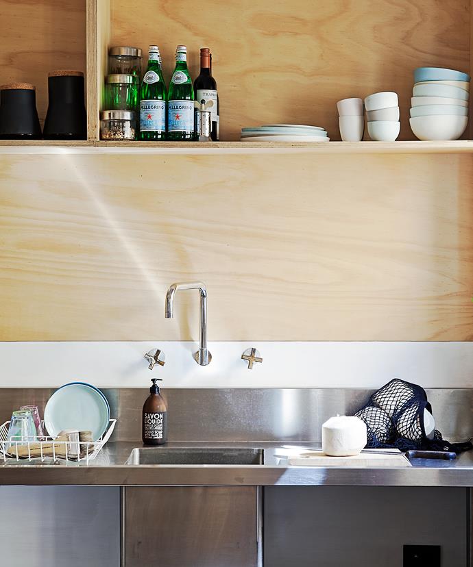 In the low-budget reno a commercial sink is teamed with Reece laundry tapware for the kitchen.