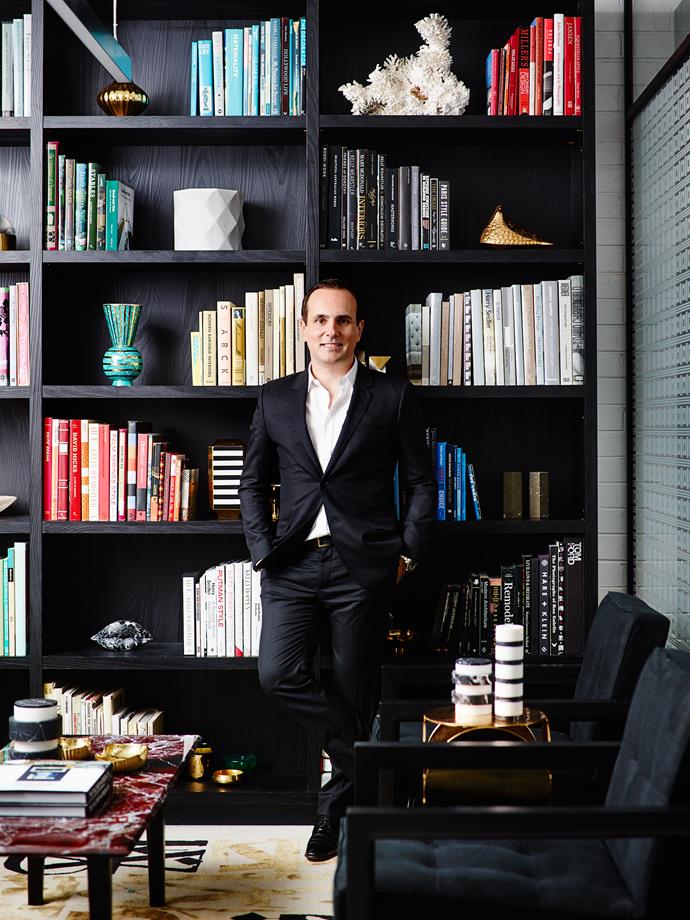 Greg Natale in his library - with colour coded bookshelves, of course. Photo: Anson Smart