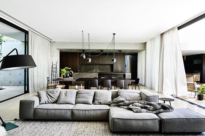 Pietra Grigio marble enlivens the timber and concrete backdrop. This is a house whose "dichotomy of raw and refined materials contrast and complement", says architect John Bornas.
