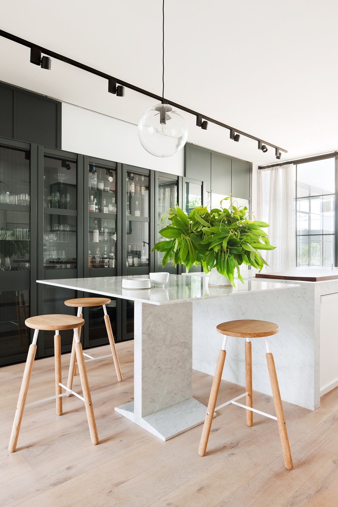 What was once an [inner-city Melbourne pub](https://www.homestolove.com.au/last-drinks-luxe-melbourne-pub-conversion-3749|target="_blank") is now a family home with sophisticated Scandi style. The expansive rooms allowed architect [Hecker Guthrie](https://www.heckerguthrie.com/|target="_blank") and interior designer [Simone Haag](https://www.homestolove.com.au/stylist-simone-haags-seamless-scandi-style-home-4012|target="_blank") to push the spaces to new heights. This kitchen, for example, features a bench which is for breakfast by-day and for cocktails by-night.