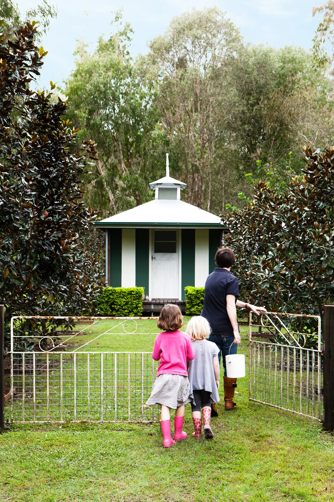 Albertine, six, and Gardenia, five, collect eggs from the pavilion-style chook pen at a [property in rural Queensland](https://www.homestolove.com.au/shacked-up-designers-find-the-perfect-family-fit-3817|target="_blank"). *Photo: Maree Homer*