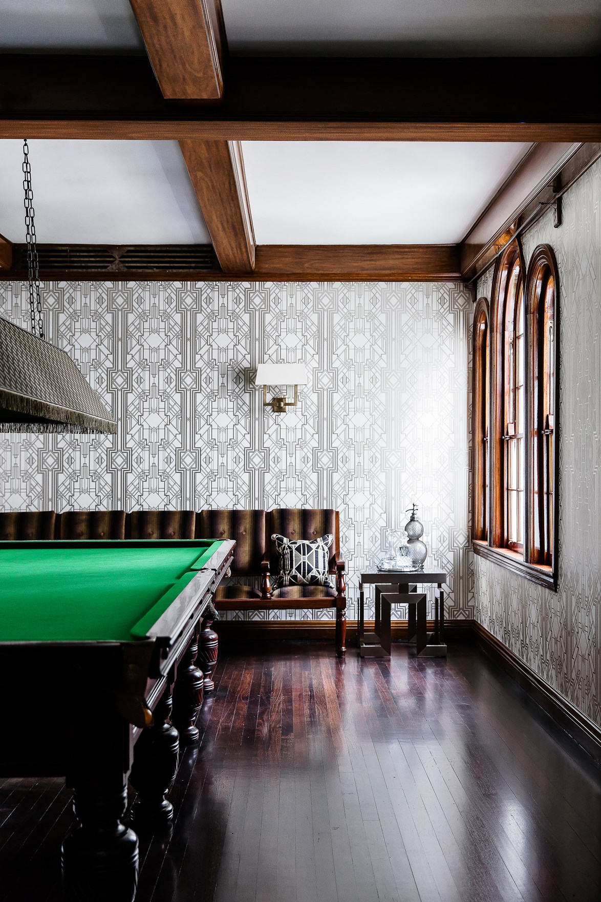 Taking design cues from it's heritage, the rumpus room in this early [20th-century home](http://www.homestolove.com.au/a-cheerful-and-kid-friendly-home-renovation-3774), has been wallpapered in an art-deco style print. When paired with exposed beams and trimmings, this style of wallpaper creates a sense of grandeur and old-world charm.
