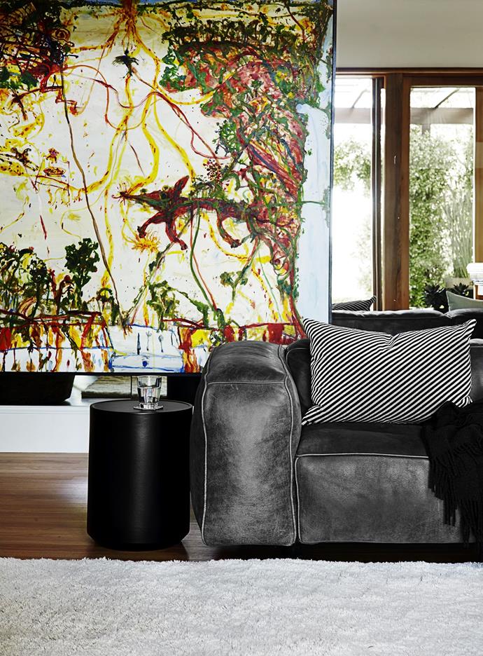 A leather sofa is softened with a throw and striped cushion. Teamed with the plush rug, the living room of this [chic Sydney home](http://www.homestolove.com.au/gallery-chic-sydney-home-with-harbour-views-1503|target="_blank") is considerably cozier. Photo: Anson Smart.