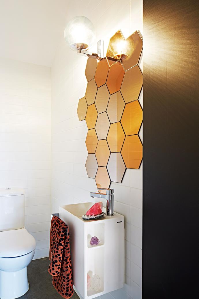 **Mirror mirror.** The eye-catching honeycomb design of this mirror wall makes a huge impact in a small space. Over-sized lighting further emphasises the stylish feature and creates the illusion of space. *Photo: Armelle Habib / bauersyndication.com.au*