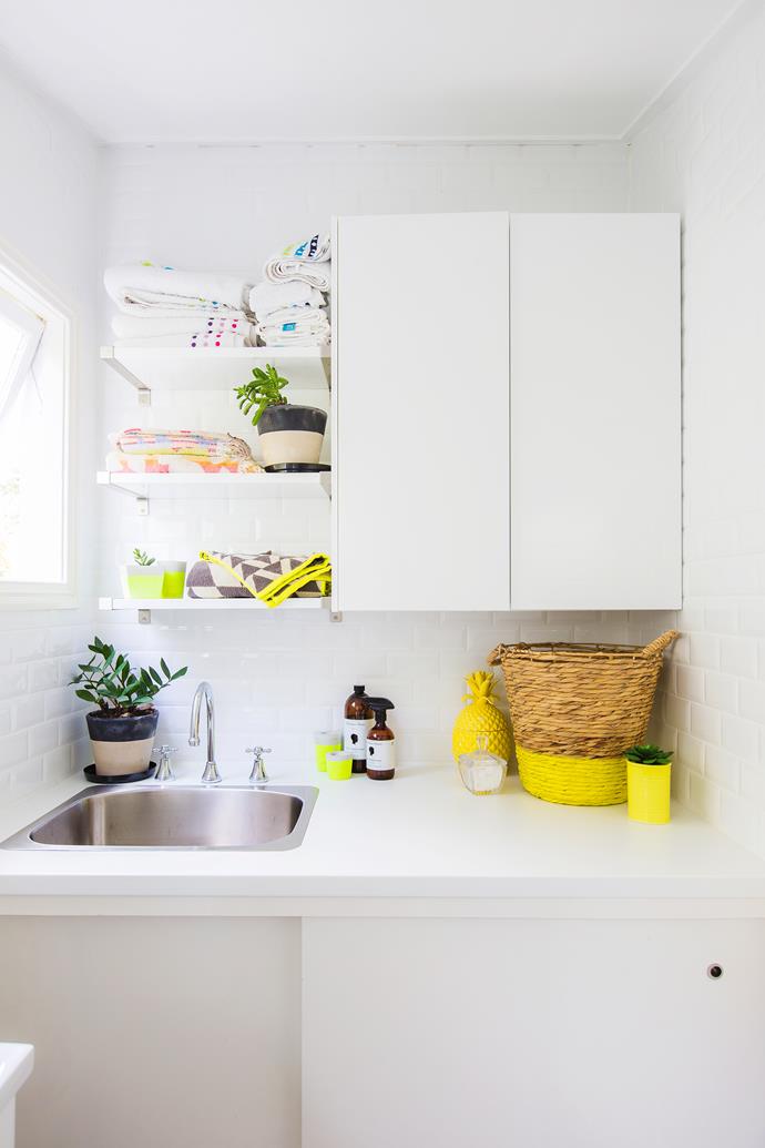 Custom-built cabinets and Ikea shelves maximise useful space in the laundry.