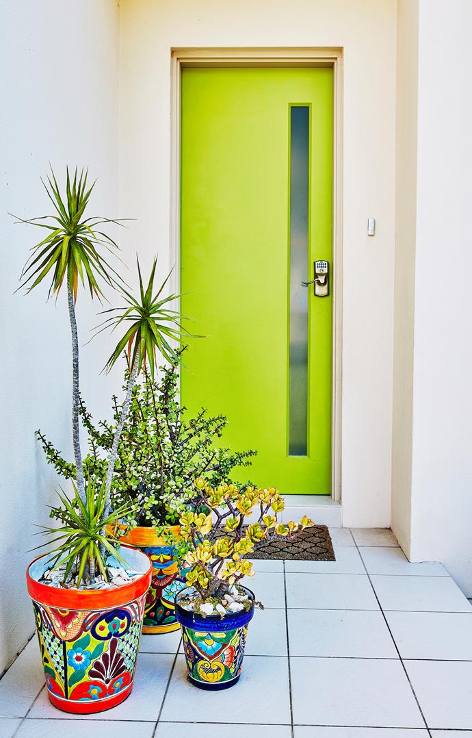 A grouping of pots, teamed with a bold front door, makes a striking entrance. Photo: bauersyndication.com.au