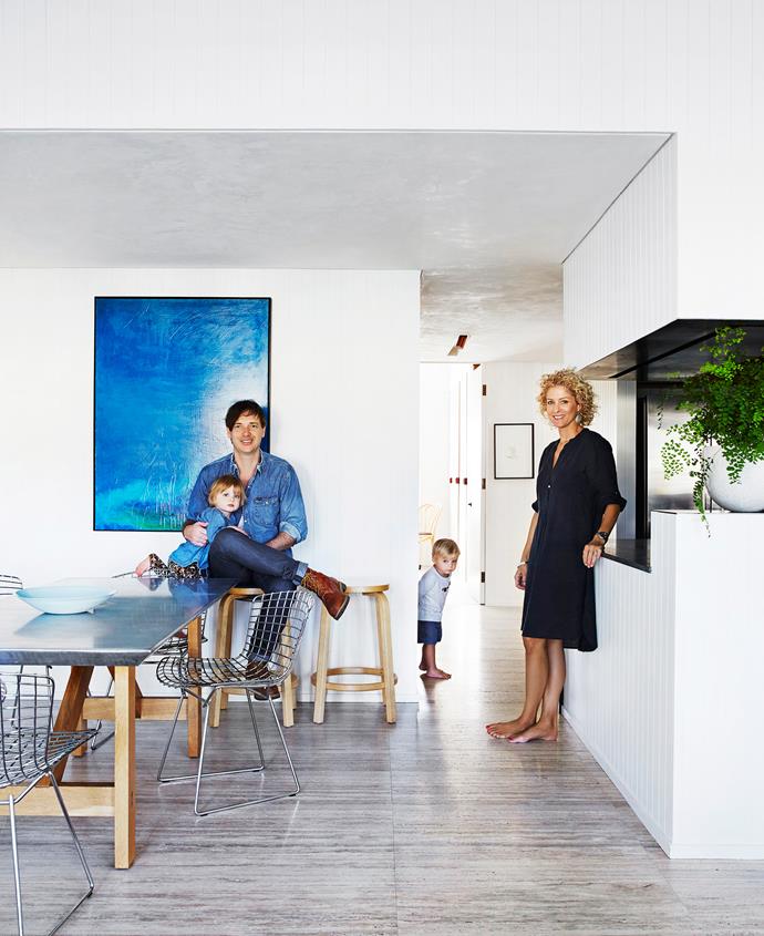 Andrew and wife Georgie with twins Leni and Beckett in their transformed space. New 2.9m-high ceilings, walls and a floor were added, as well as recessed lighting, to an area that used to have grey carpet, rounded walls and [pendant lighting](http://www.homestolove.com.au/14-pendant-lights-that-pack-a-punch-2989|target="_blank"). Andrew created the artwork he’s in front of as well as the zinc-topped dining table. The stools are [Artec](http://www.artek.fi/products/chairs/128|target="_blank"|rel="nofollow") and the Bertoia chairs are from [Dedece](http://www.dedece.com/|target="_blank"|rel="nofollow").