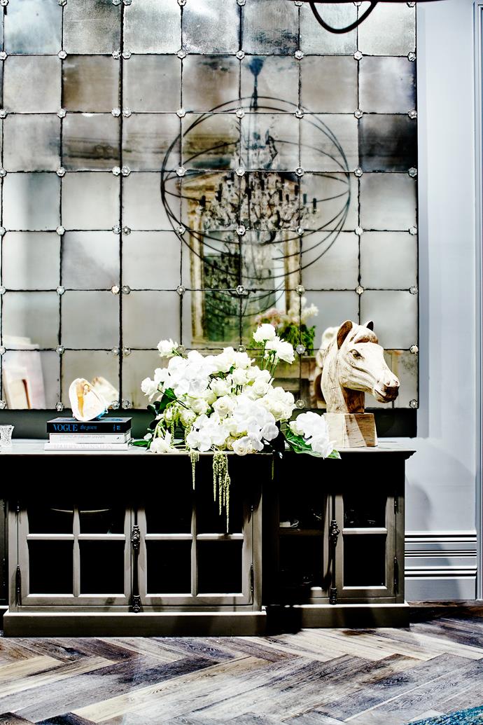 Luxe details in the entry hall include the chandelier, mirror and horse’s head, all from [Restoration Hardware](https://www.restorationhardware.com/|target="_blank").