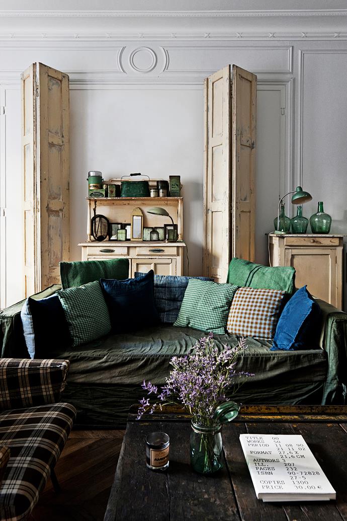 The elegantly organic living room is a welcoming sight on first entering the flat. Homeowner Arianne Dalle dyed the fabric on the sofa, which is cosied up with a swag of cushions – some made from old flour sacks.