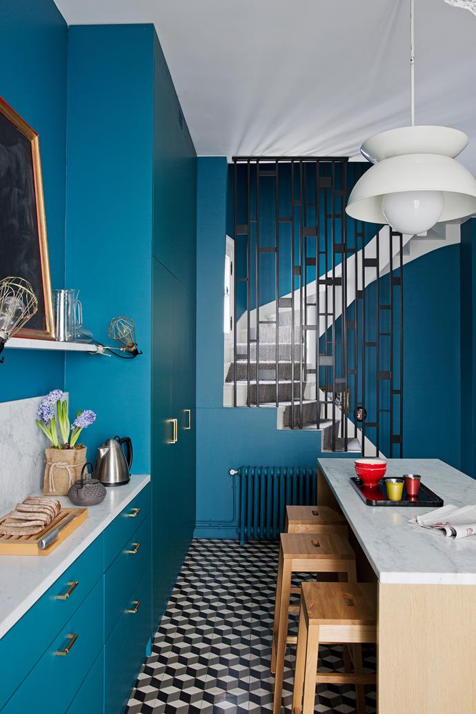 Access to the apartment is through the hallway and kitchen, unified by the stunning blue-painted walls and cabinetry. Skilfully tempered by natural oak, marble and tile, there’s more relief in the white ceiling and over-bench lamp.