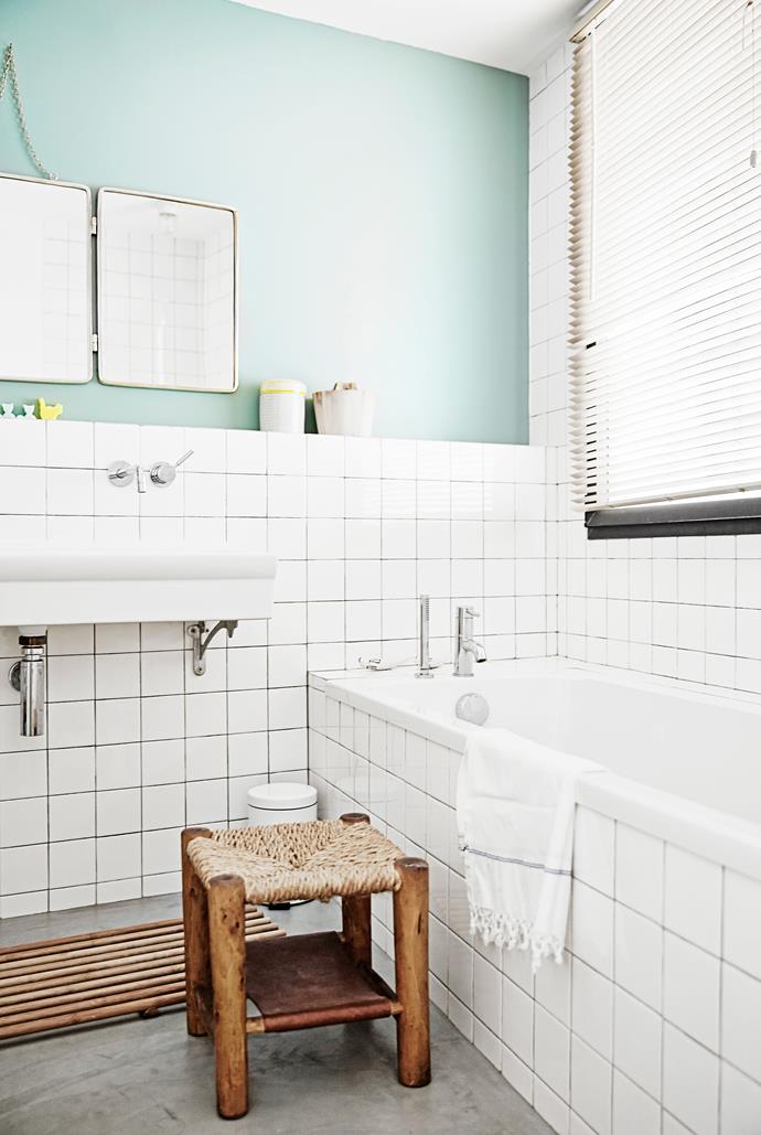 White tiles and a green wall give the children’s bathroom a retro feel.