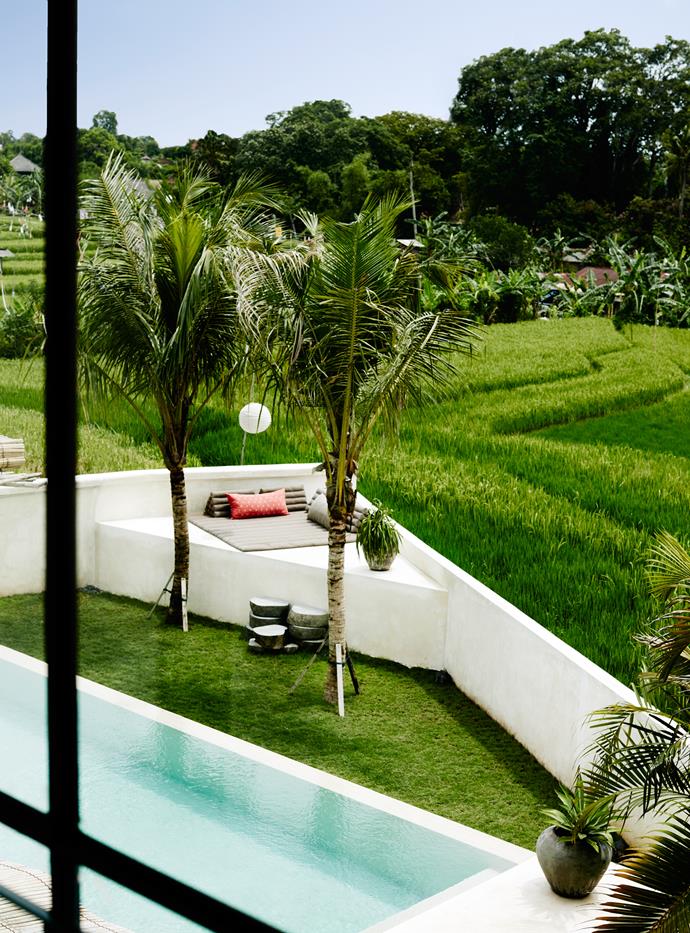 The swimming pool sparkles against the brilliant green of the rice paddies beyond. A triangular-shaped lounging platform is the perfect spot for catching the sunset.