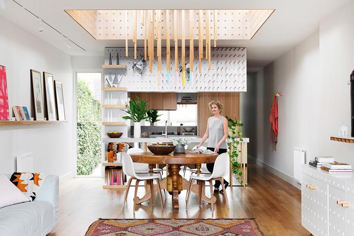 Fiona oversaw the creation of the laminate and Victorian-ash joinery that features throughout, including the kitchen’s display wall and the colour-dipped timber-dowel chandelier hanging from a light well above the dining table.