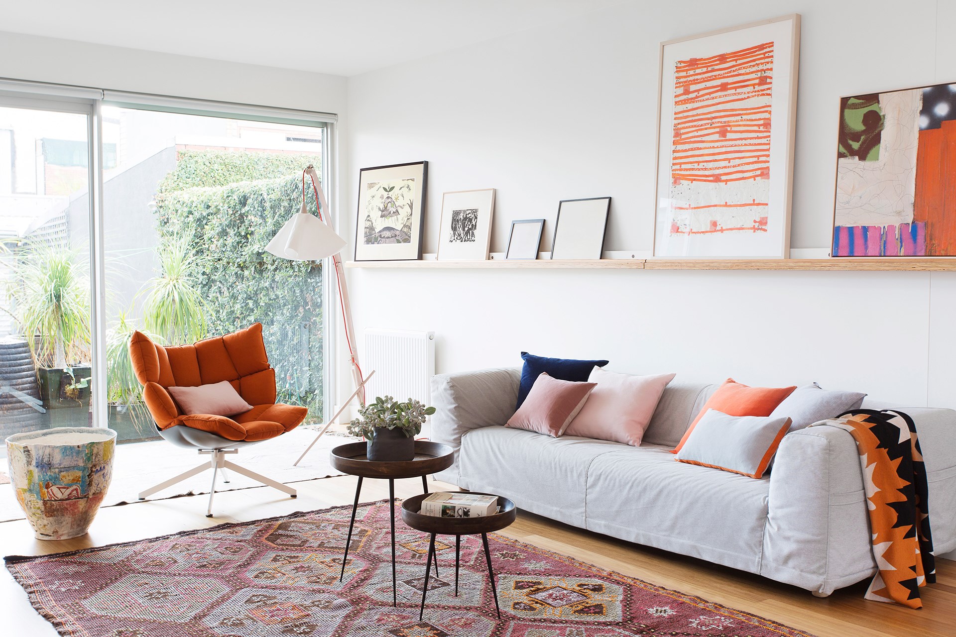 This light-filled living room is brought to life with bursts of burnt orange and terracotta, contrasted perfectly with soft pink and grey for a vibrant yet sophisticated style. [> See the rest of this bespoke Melbourne terrace here.](http://www.homestolove.com.au/bespoke-renovation-of-an-old-victorian-terrace-4456) Photo: Martina Gemmola / Australian House & Garden
