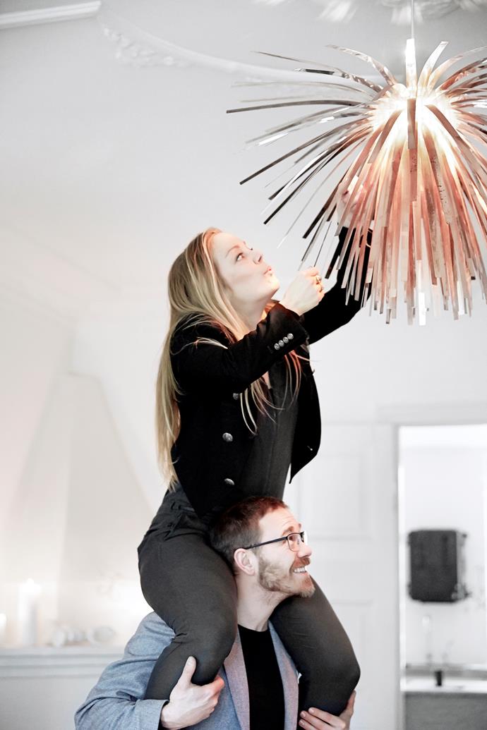 Marcus wobbles as Karina hangs a trio of self-assembly Snowflower pendant lights – one of the couple’s designs – over the dining table at different heights for a light-installation effect.