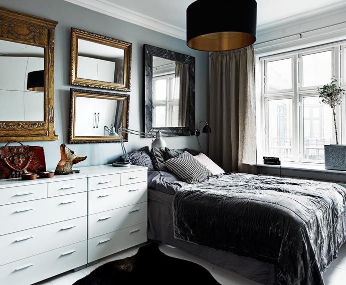 A wall of mirrors in the bedroom reflects light and “doubles” the space. Identical chests pushed up together provide lots of storage, and a generous display surface.