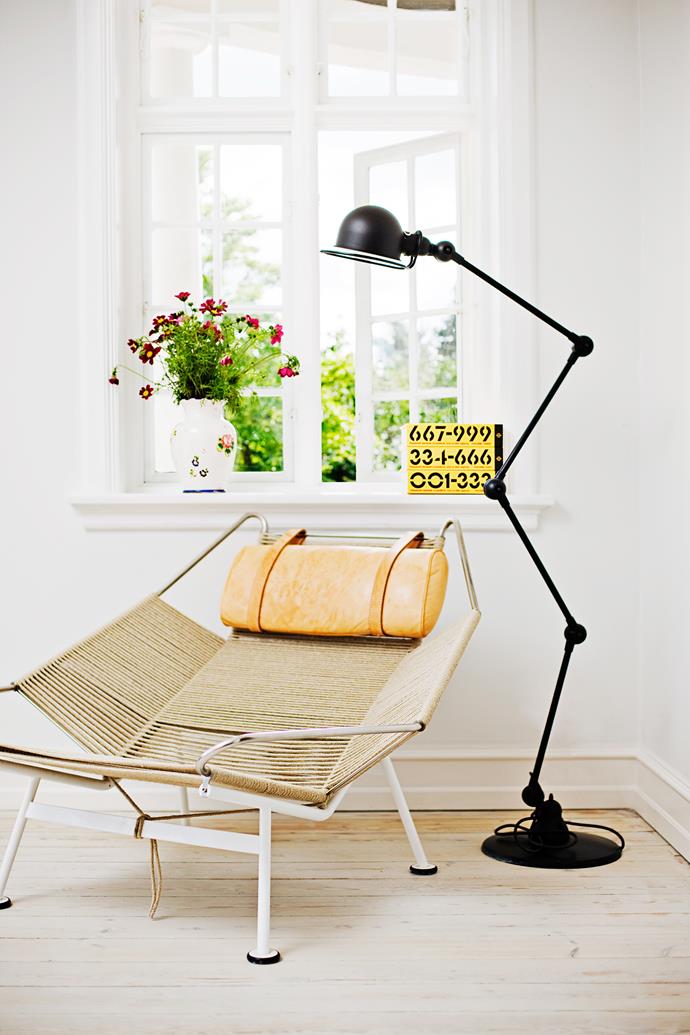 Designer buys: A Hans Wegner “Flagline” chair and a Jieldé floor lamp decorate a corner of the living area.