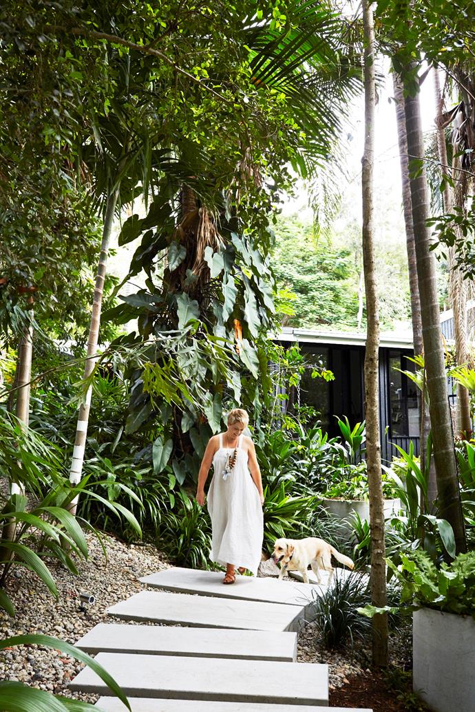 Vanessa traverses a walkway of custom-made concrete pavers with Rio, a golden labrador withdrawn from the Seeing Eye Dogs Australia program for being too 'flighty' but now in her element as a much-loved pet.