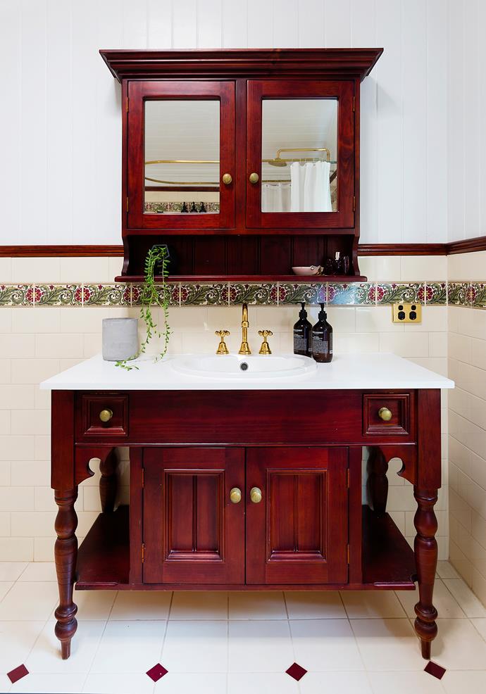 The original bathroom vanity was refurbished with a new stone top, sink and tapware, and the timber and brass polished up.